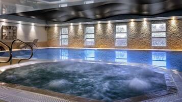A hot tub with a textured wall and windows.