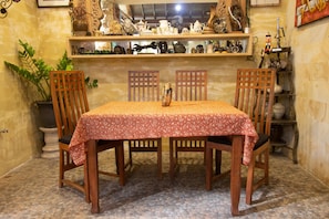 Cozy dining area with a table set for four, surrounded by comfortable chairs and decorative items.