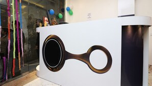 A reception desk with a modern design, featuring a circular handle and a black accent. - OYO 13774 Check In Room (New Delhi)