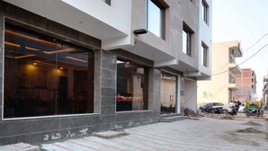 A building with large windows and a paved entrance area. - OYO 27061 Hotel Magnum (Mohali)