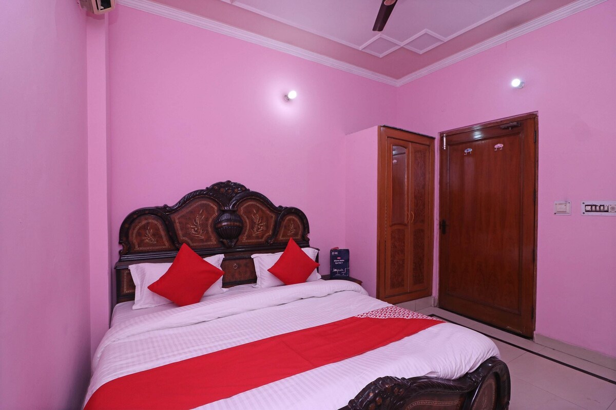 A bedroom with a large bed, wooden headboard, and two doors.