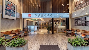 A hotel lobby with a reception desk, seating areas, and a large framed artwork on the wall. - Edoya Hotel Ben Thanh (Ho Chi Minh City)