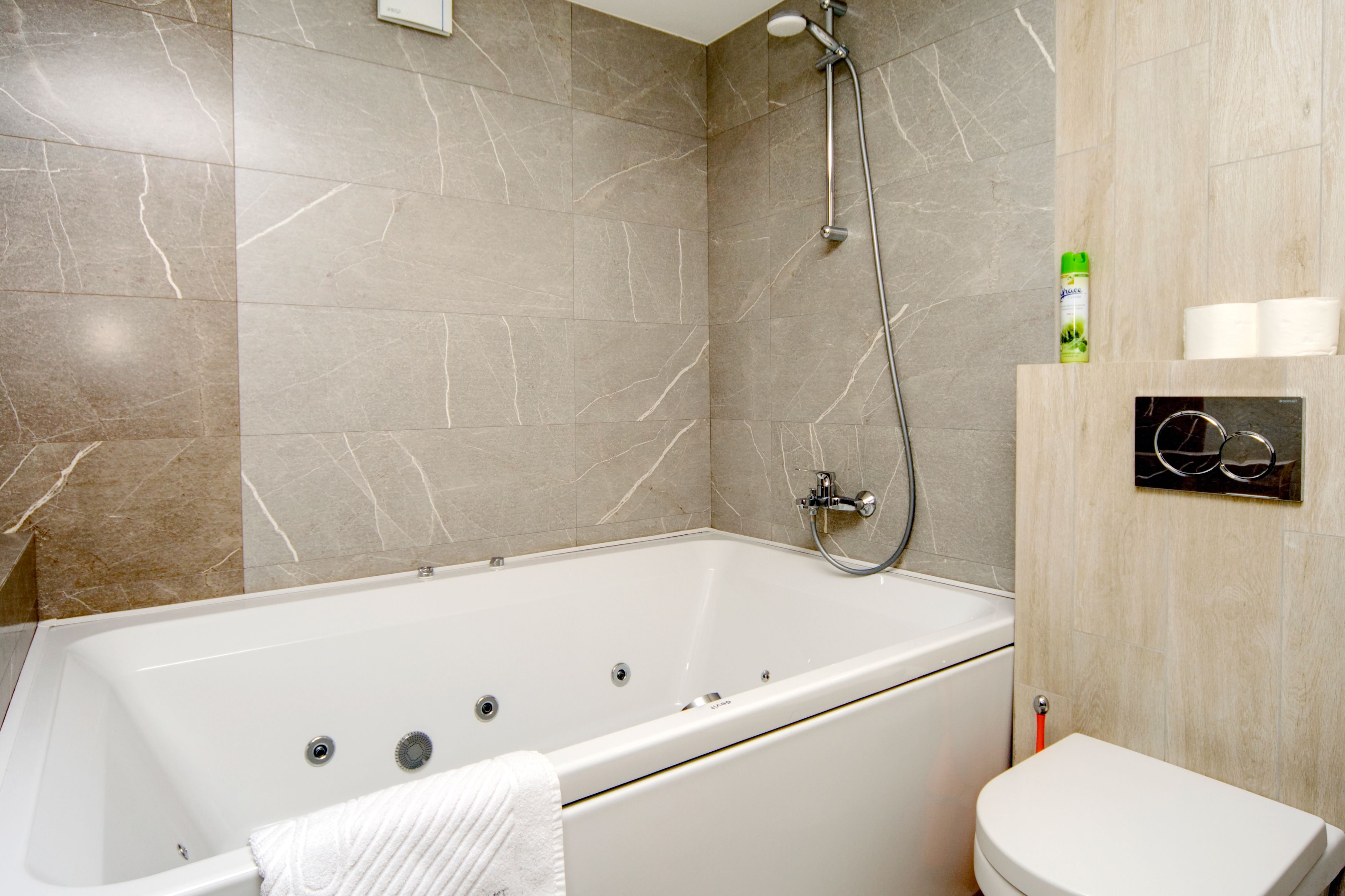 A bathroom with a bathtub, toilet, and shower.