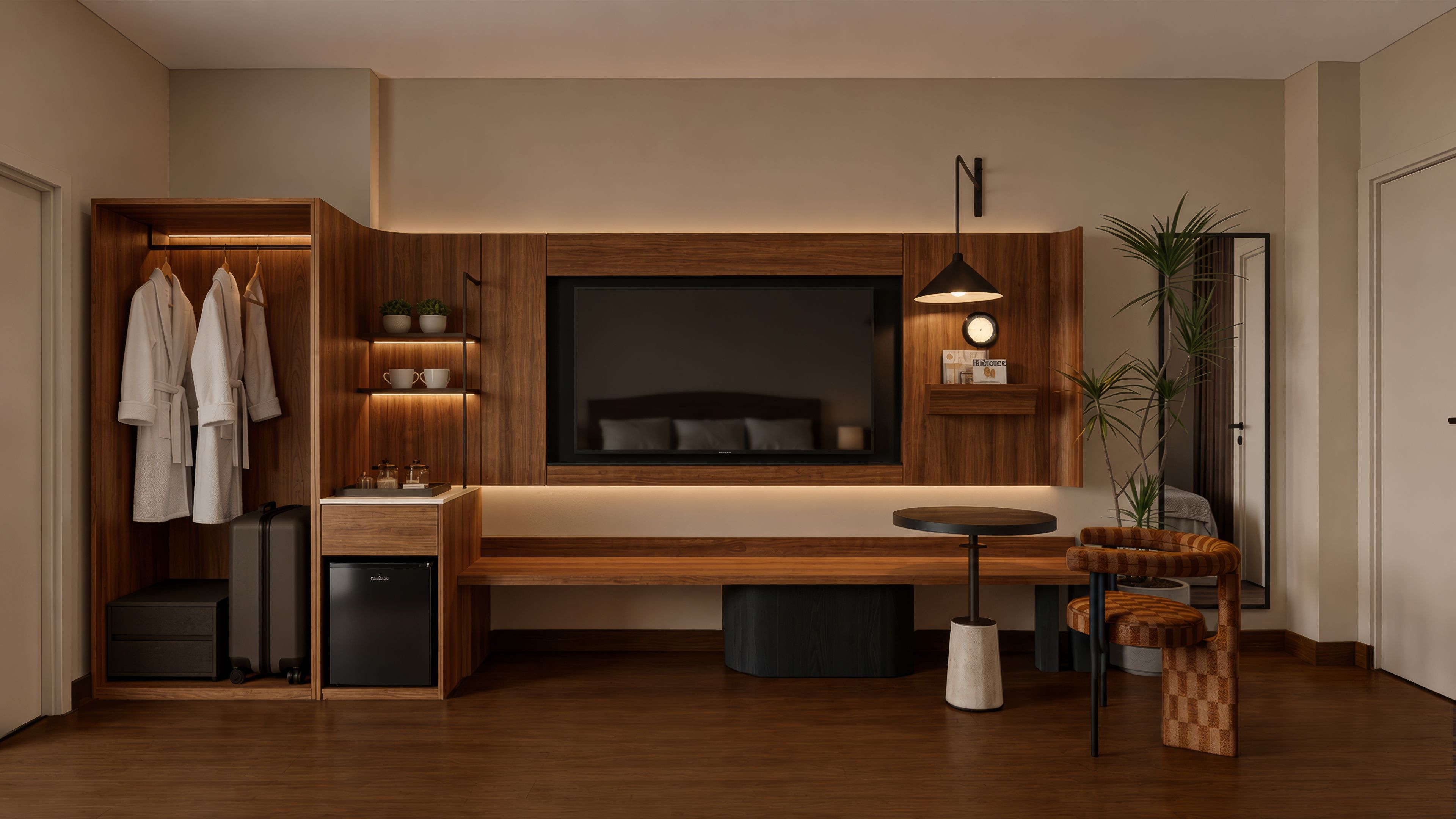 Ein modernes Schlafzimmer mit einem großen Bett, Nachttischen, einem Fernseher und einer Sitzecke mit kleinem Tisch und Stuhl.