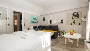 Design Studio, 1 Double Bed, Kitchenette, City View | Living area | Flat-screen TV