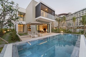 Un hôtel moderne doté d’une piscine, d’un espace extérieur aménagé et d’un jardin bien entretenu.