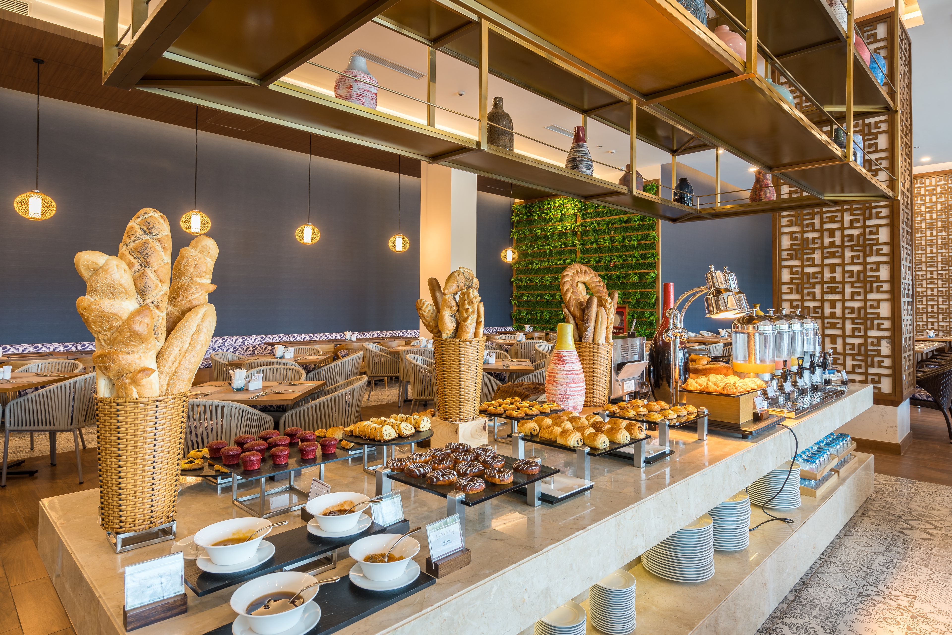 A buffet area with various food items and a seating area with tables and chairs.