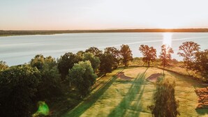 A golf course with a water body in the background and trees around. - Skyrup Golf & Hotell (Tyringe)