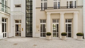 A building with a modern facade, large windows, and a central entrance with columns. - No.4 Residence (Warsaw)