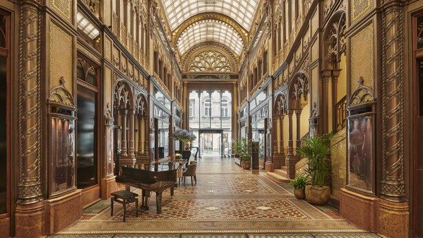 A grand hallway with ornate columns, a grand piano, and a patterned carpet. - Párisi Udvar Hotel Budapest, part of Hyatt (Budapest)