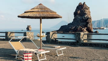 Private beach, black sand, sun loungers