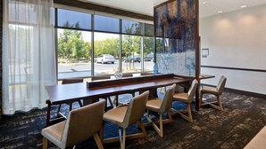 A hotel room with a large window, a wooden table, and four chairs. - Hyatt Place Fresno (Fresno)