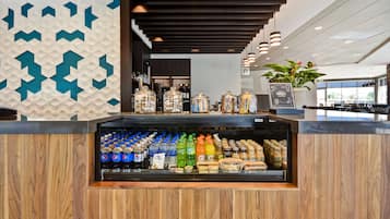 A beverage display with various drinks and condiments, wooden paneling, and a modern interior design.