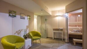 A modern spa room with a glass shower, a wooden sauna, and two bright green chairs. - Cafe-Pension Erika (Eben am Achensee)