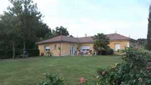 A two-story house with a red-tiled roof, a front lawn, and a garden with roses. - Alaguyauder La Chambre (Chatillon-sur-Broue)