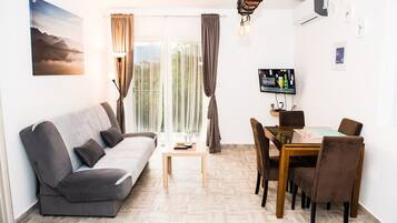 Apartment, 1 Queen Bed with Sofa bed, Sea View | Living area | 32-inch flat-screen TV with cable channels, Smart TV, Netflix