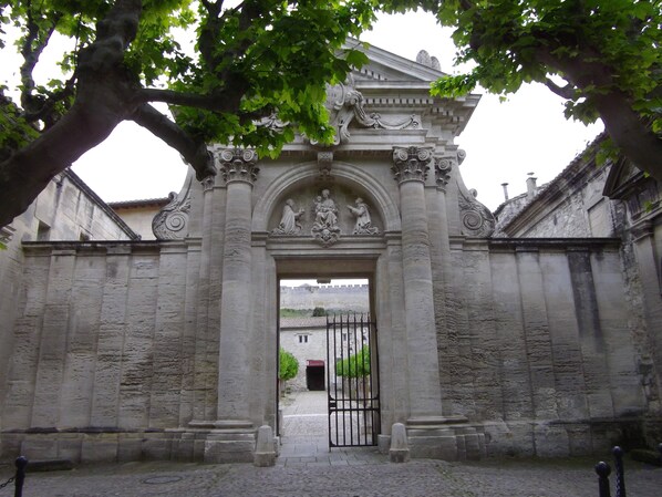 A stone entrance with classical architectural details, including columns and decorative reliefs.