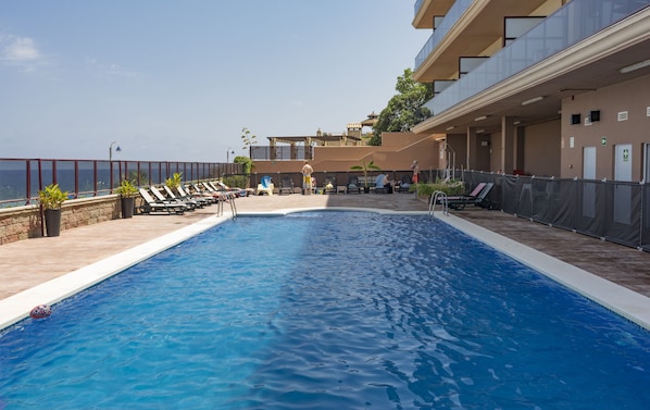 Seasonal outdoor pool, open 10:00 AM to 9:00 PM, sun loungers