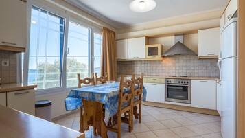 Standard Apartment, Sea View | Private kitchen | Full-size fridge, oven, stovetop, electric kettle