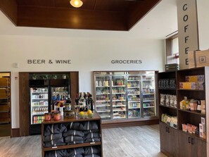 A store with sections labeled 'Beer & Wine' and 'Groceries,' featuring shelves stocked with various items.