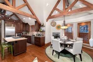 Enjoy meals in the kitchen with an oven and dining area featuring a round table and chandelier.