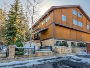 A modern multi-story building with a wooden facade and large windows. - Ski the greatest snow on earth! (Park City)