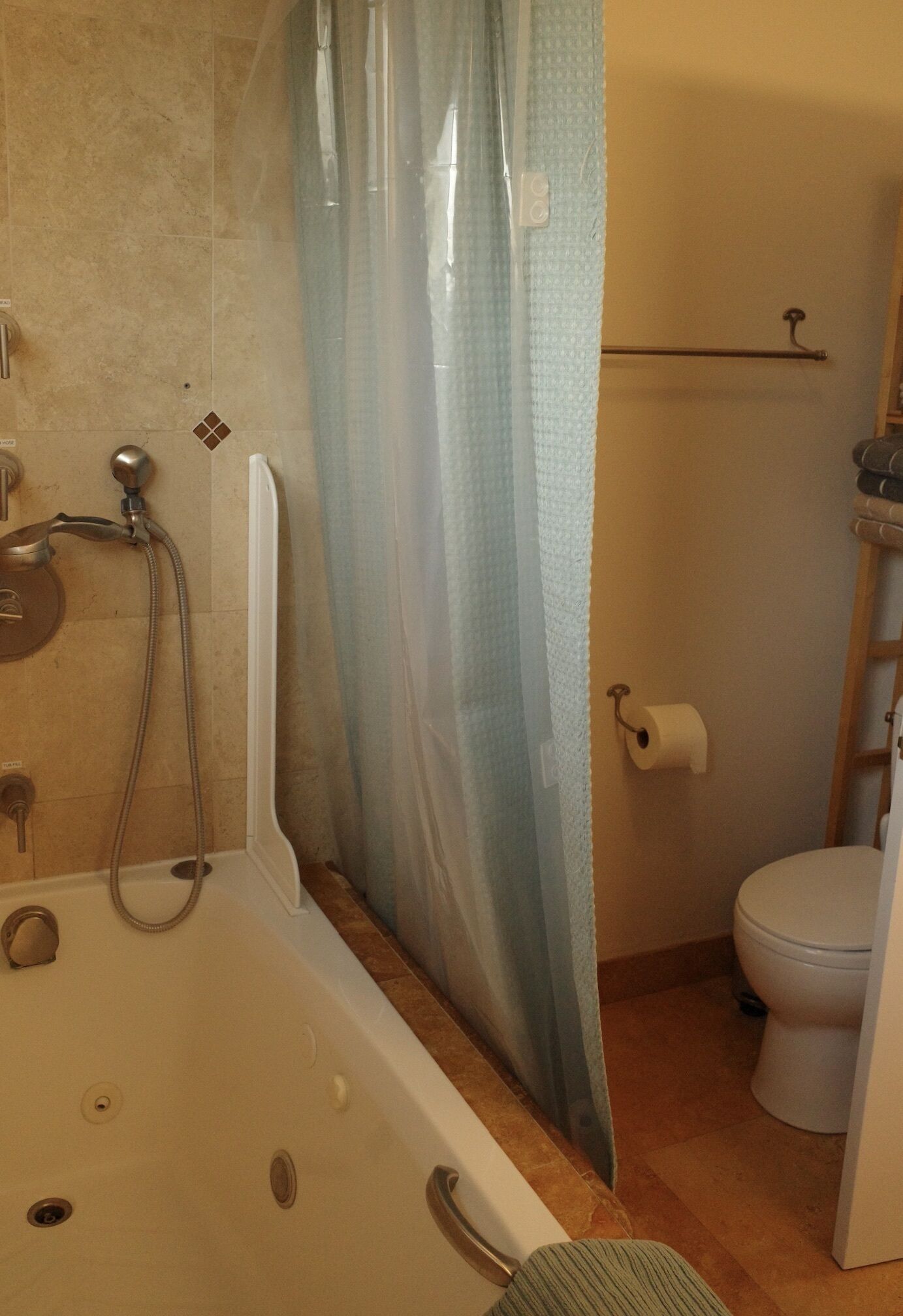 A bathroom with a bathtub, toilet, and shower.