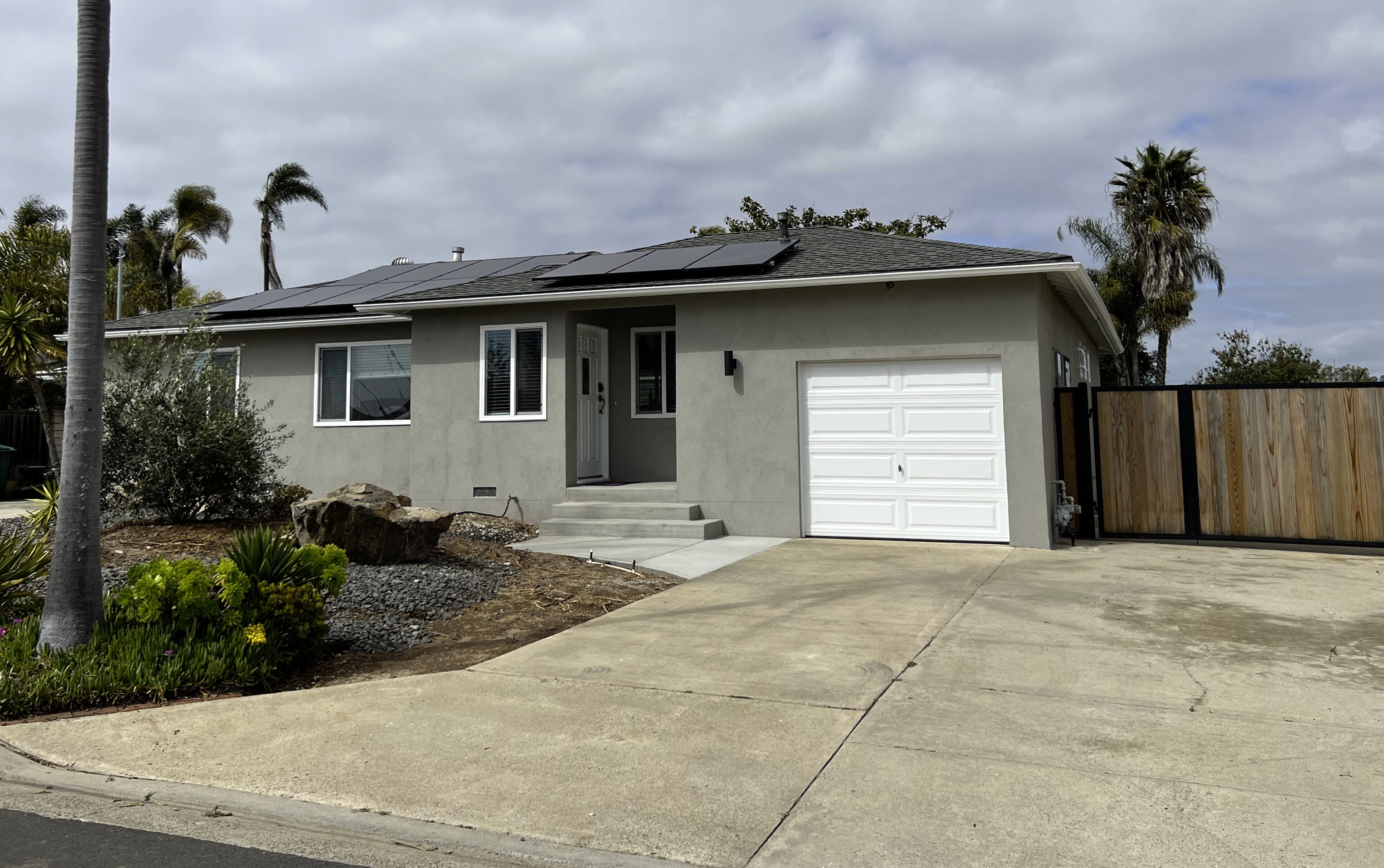 A single-story house with a garage, a front porch, and a driveway.