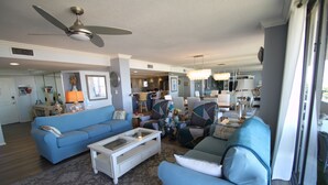 A spacious living room with a ceiling fan, a coffee table, and two sofas. -  Luxury 2400 Sq Ft Condo w/ Epic Views, Private Beach Access, Large Pool (Siesta Key)