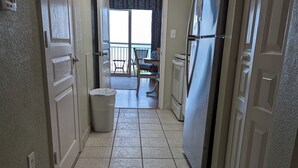 A narrow hallway with tiled flooring leading to a balcony with a view. - Beautiful oceanfront condo - Bay Watch Unit 338 (North Myrtle Beach)