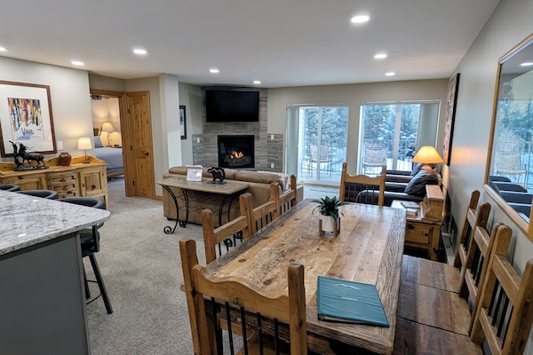 Living room with sofa bed, gas fireplace, and balcony w/ propane BBQ grill