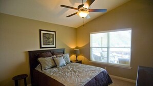 A bedroom with a bed, a ceiling fan, a window with blinds, and a framed picture on the wall. - 3BR/2BA Lakefront Property, Includes Boat Slip (Osage Beach)