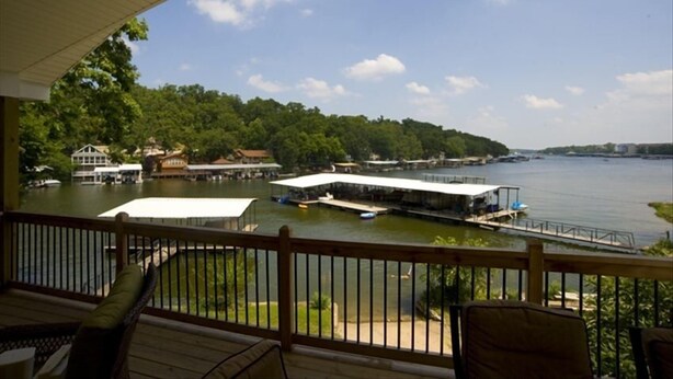 A lakeside view from a covered deck with boats and docked houses. - 3BR/2BA Lakefront Property, Includes Boat Slip (Osage Beach)