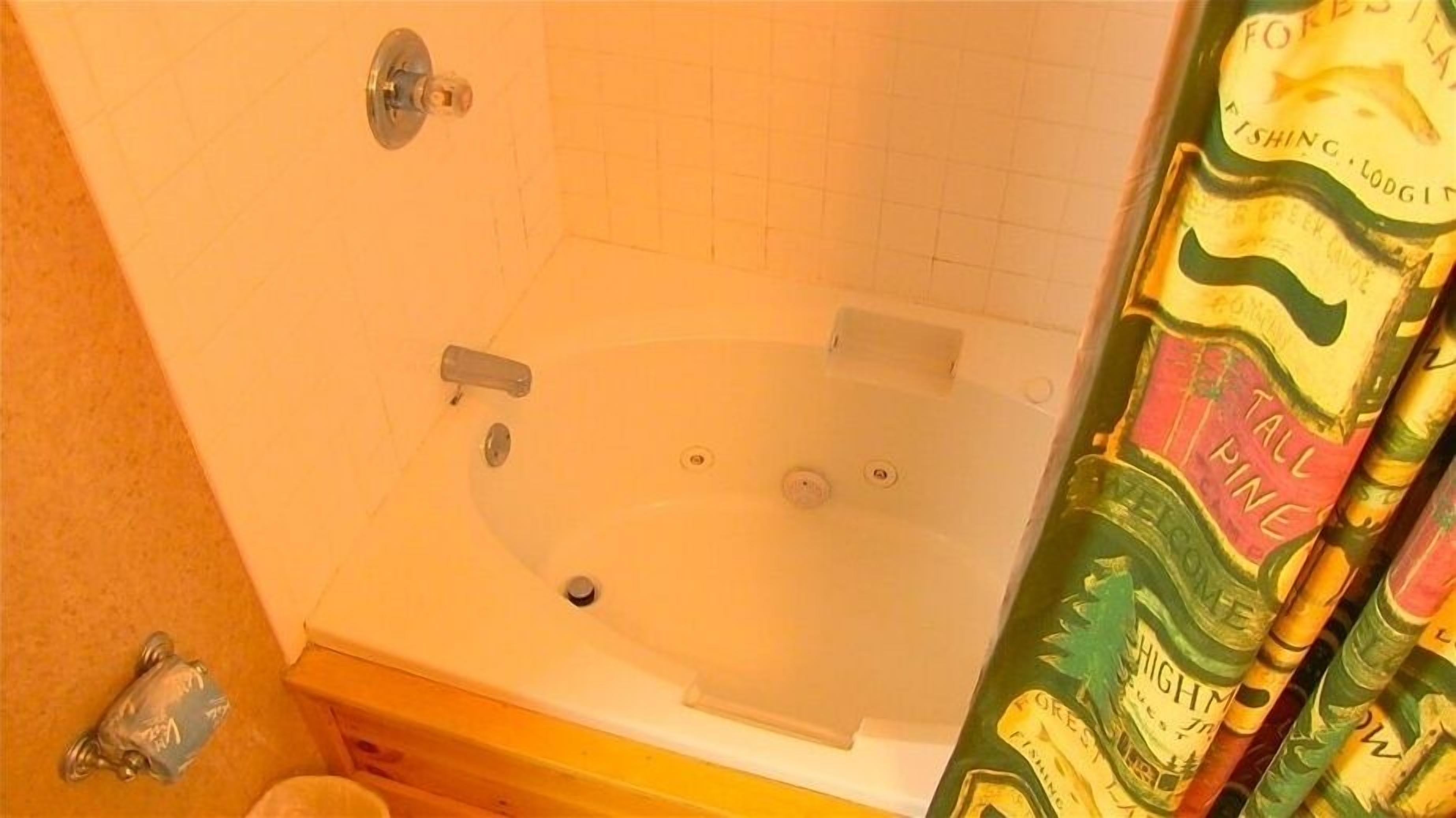 A bathroom with a bathtub, a shower, and a toilet.