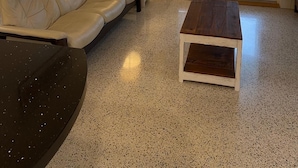 A living room with a beige sofa, a wooden coffee table, a floor lamp, and a ceiling fan. - A GEM-Beach Cottage 4 BR,Heated Pool on Canal, 1 Block To Village, Walk to Beach (Sarasota)