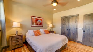 A bedroom with a wooden floor, a bed with white bedding, two bedside lamps, and a ceiling fan. - 3B/2B Modern Downtown Moab Townhouse - Short Walk from the Heart of Downtown (Moab)