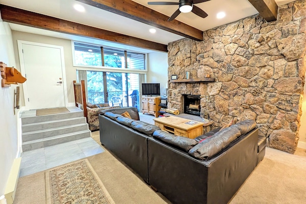 Living room with wood fireplace and balcony w/ propane BBQ grill