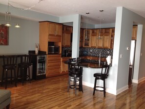 Enjoy cooking in this well-equipped kitchen with a central island and bar stools.