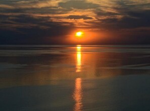Experience serene sunsets by the water, with a tranquil atmosphere and breathtaking views.
