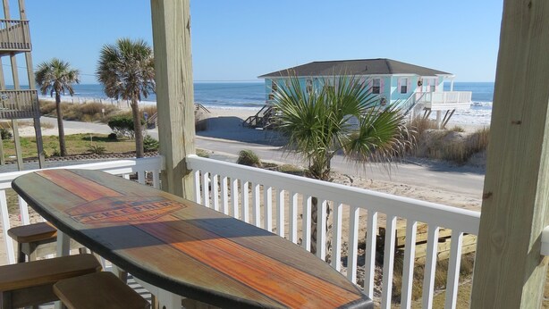 A wooden deck with a long table and benches overlooking a beach. - "The Palms" Oceanfront on Topsail Island, 2 BR - 2 BA Beach House - Awesome View (North Topsail Beach)