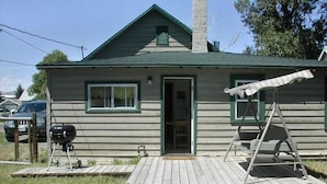A single-story wooden house with a front porch, a garage, and a small deck area. - Accepting reservations for 2027 summer! (Cody)