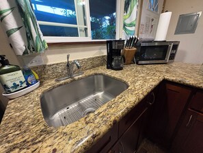 Fridge, microwave, stovetop, coffee/tea maker