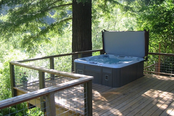 Relax in hot tub under the redwood with view of river.