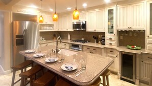 A modern kitchen with white cabinets, stainless steel appliances, and pendant lighting. - Beach1Min Disney25Min Parking W/D Bikes Fast WiFi (Newport Beach)