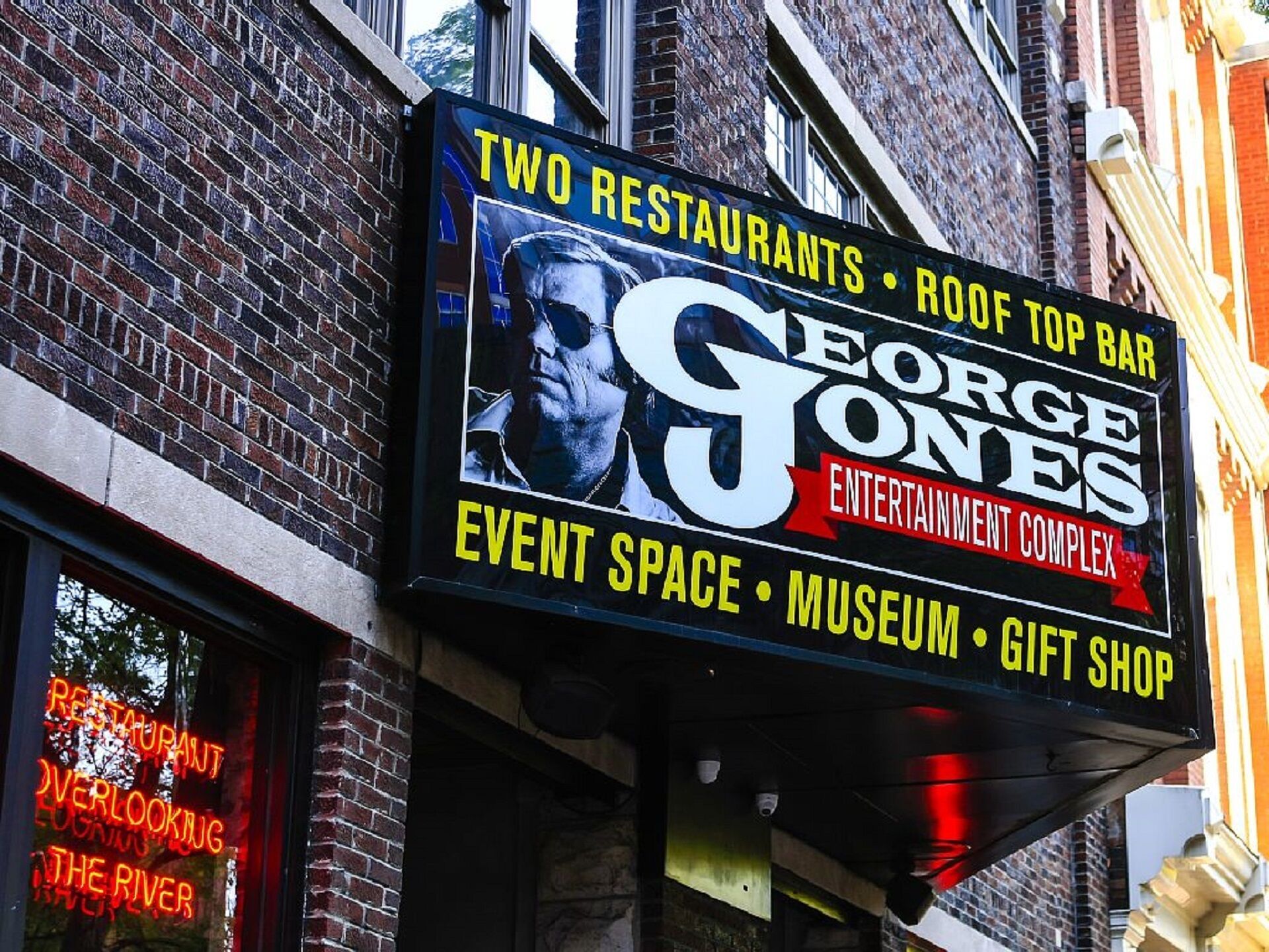 A building with a sign advertising George Jones Entertainment Complex, including event space, a museum, and a gift shop.