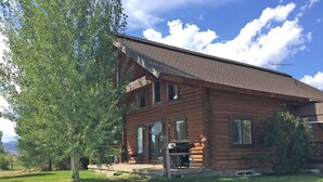 A log cabin with a porch, a satellite dish, and a grill. - Johnson's Country Cabin - One price rents the entire home! (Afton)