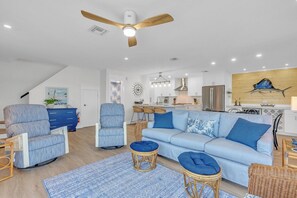 A modern living room with a sofa, armchairs, and a ceiling fan. - Rx: Paradise updated 2bed/2.5bath townhouse style condo with open water views, shared pool & dockage (Marathon)