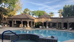 A swimming pool with lounge chairs and a hot tub, surrounded by a covered patio area with outdoor seating. - Luxury Rental in North Scottsdale-2 Bed/2Bath (Scottsdale)