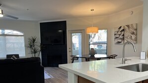 A modern kitchen with a white countertop, stainless steel sink, and wooden cabinets. - Luxury Rental in North Scottsdale-2 Bed/2Bath (Scottsdale)