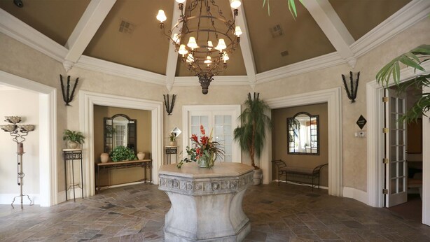 A spacious lobby with a stone floor, a central fountain, and a chandelier. - Luxury Rental in North Scottsdale-2 Bed/2Bath (Scottsdale)